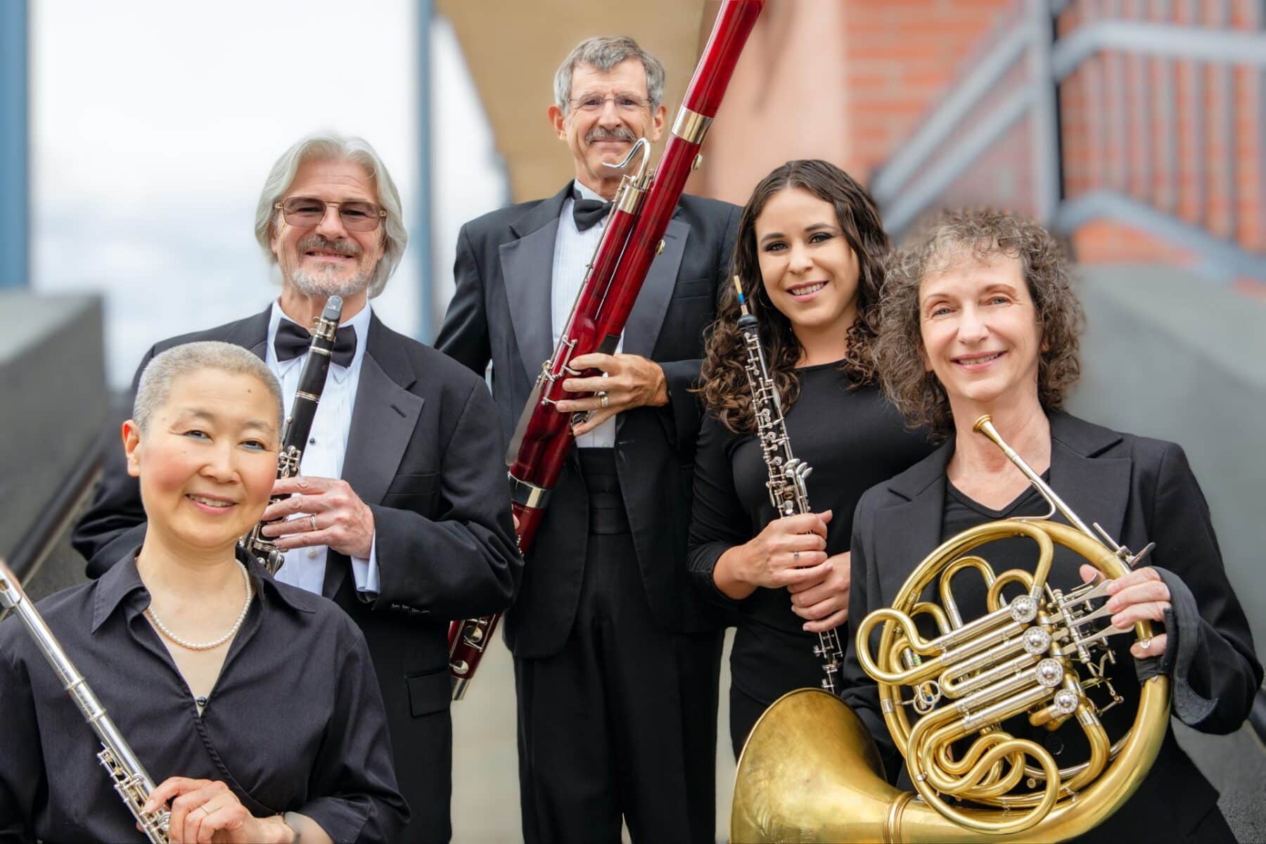 The five members of the Arizona Philharmonic Sonoran Winds Quintet pose with their respective instruments.