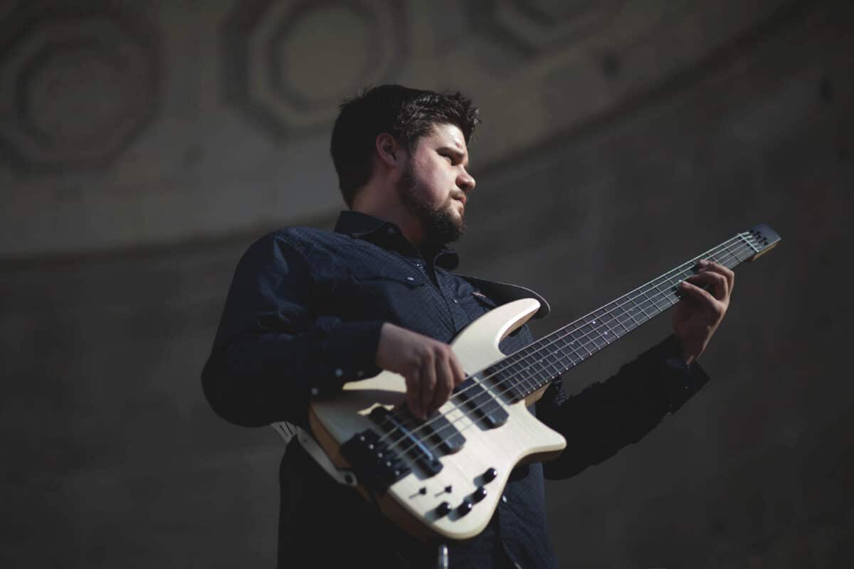 Marcos Varela plays electric bass guitar on stage