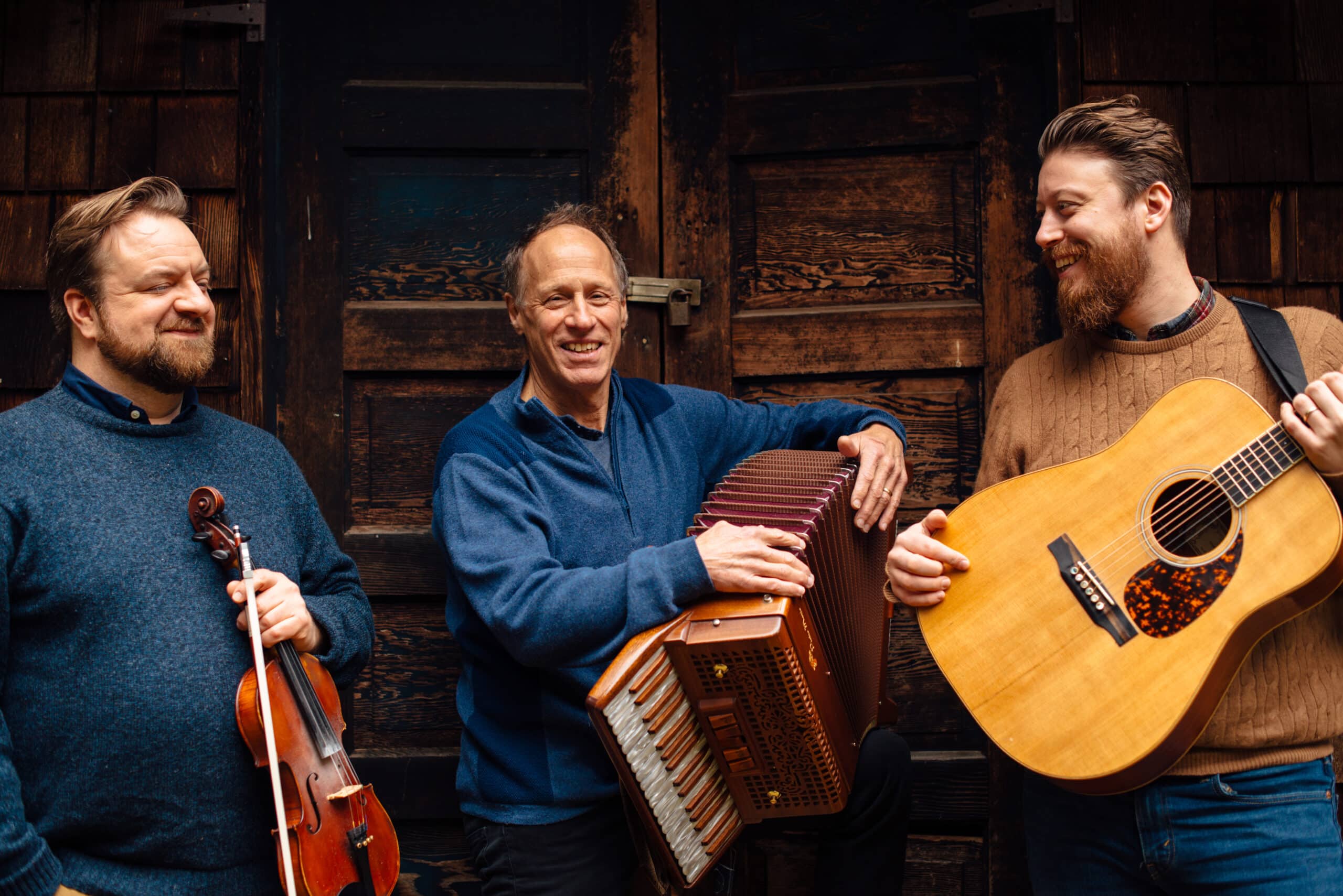 Members of Kalos smile with instruments